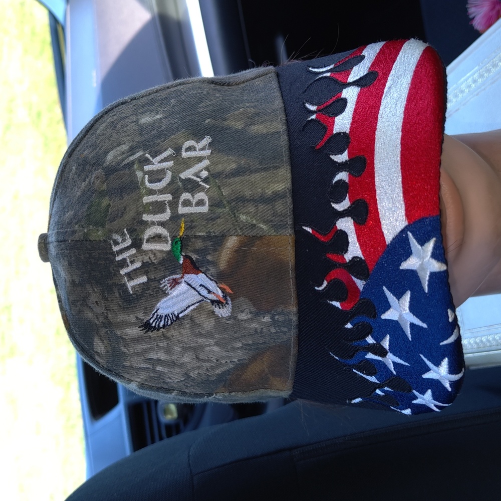 The Duck Bar Bowdon, ND Camo Embroidered Flames USA Theme Strap-on Hat Cap